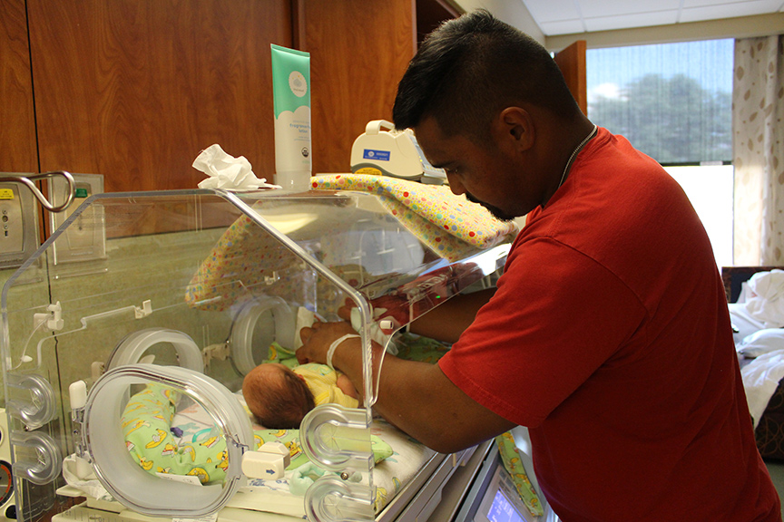 Dad changing nicu baby's diaper