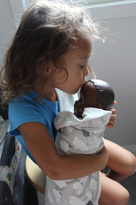 Toddler playing with doll